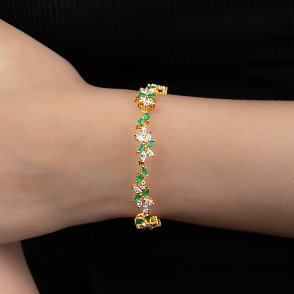 Leaf Bracelet — simulated emerald and American diamond leaf-vine bracelet in gold, worn on wrist