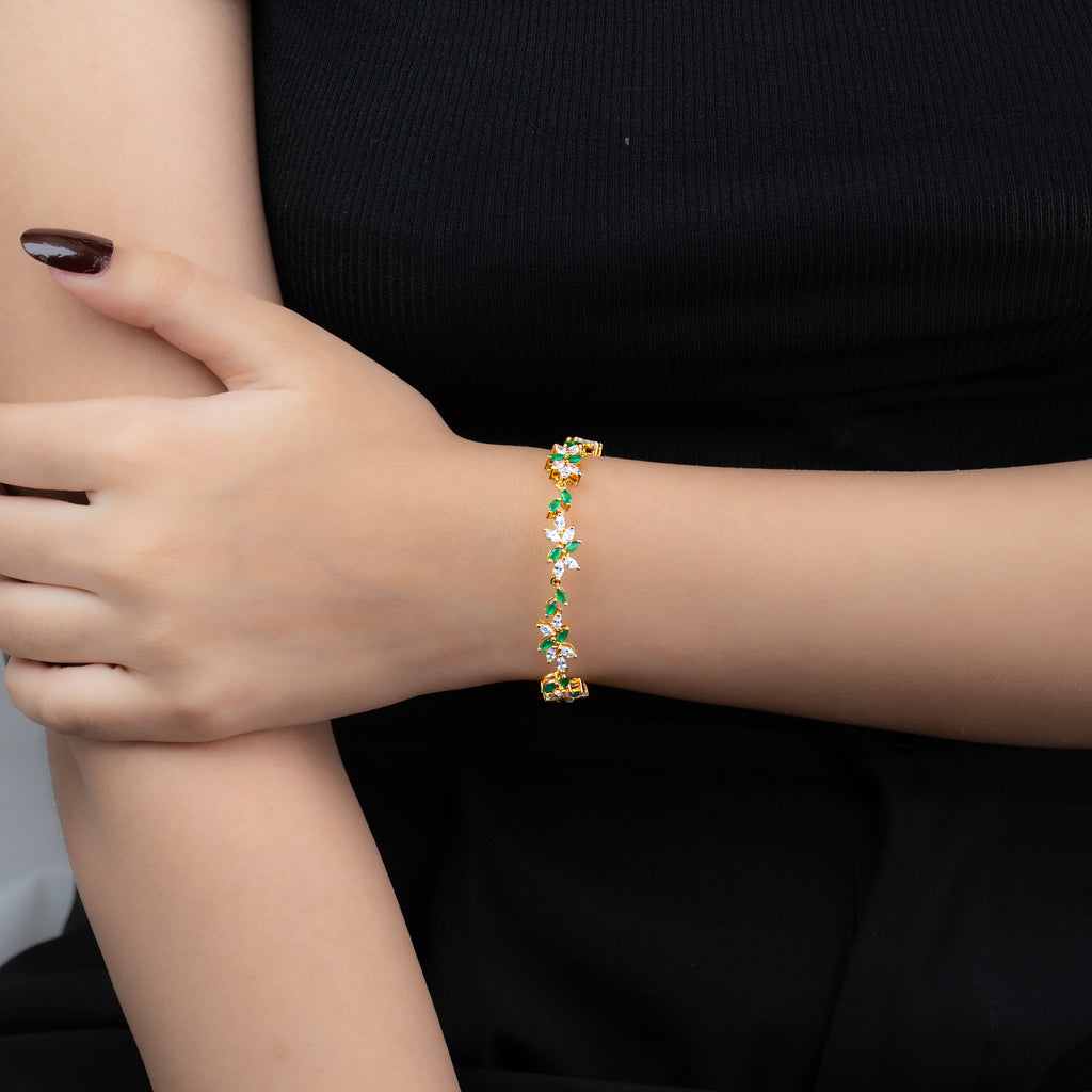 Leaf Bracelet — simulated emerald and American diamond leaf-vine bracelet in gold, worn on wrist