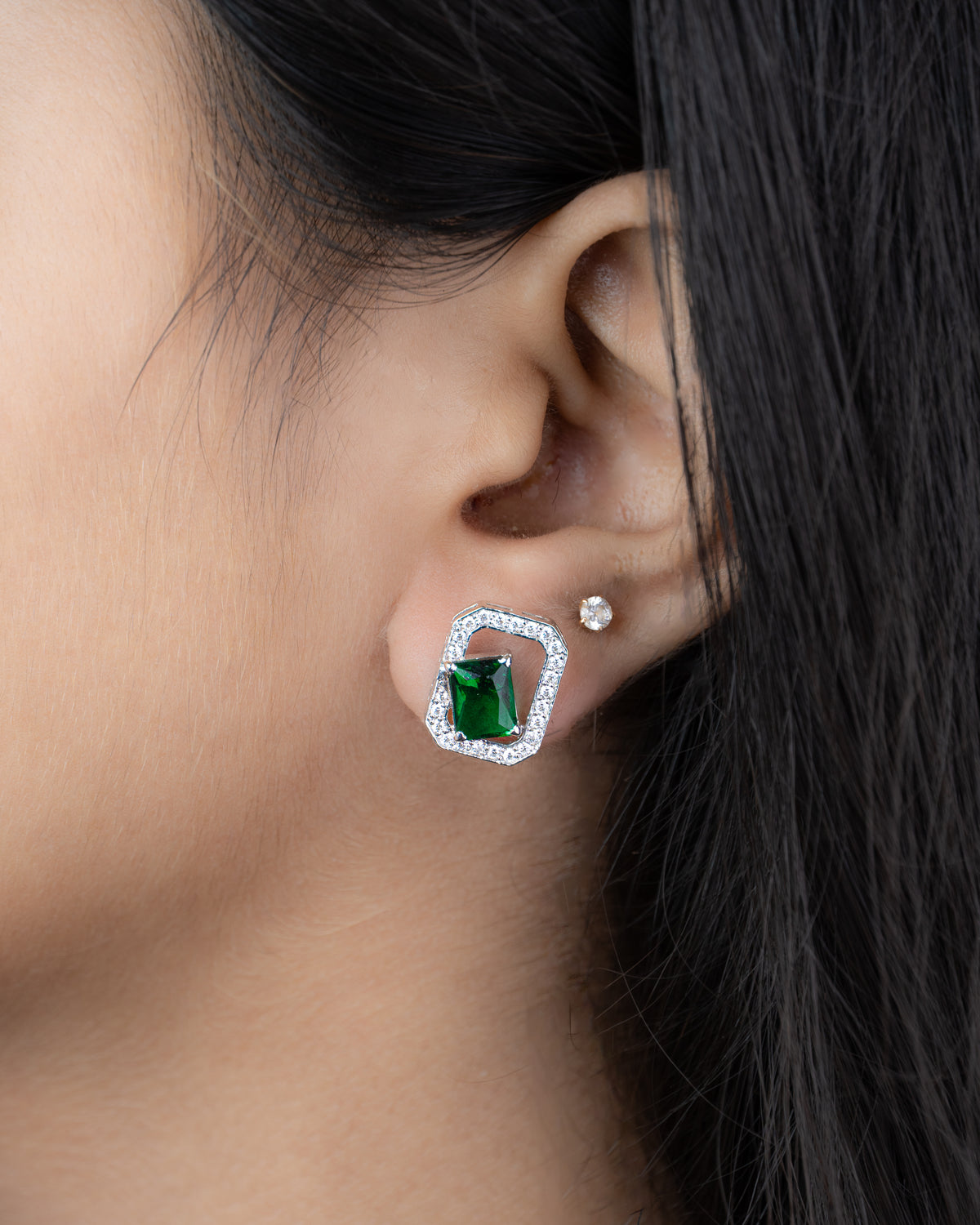 Elara Emerald Studs worn on ear, side view