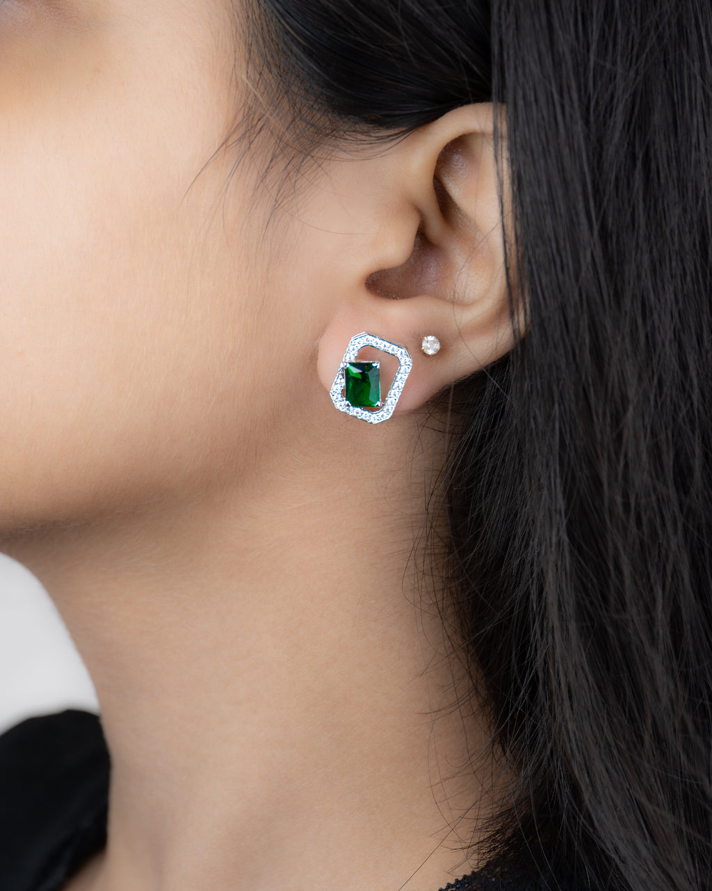 Elara Emerald Studs worn on ear