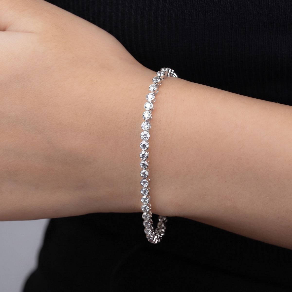 Lyra Tennis Bracelet — round bezel-set bracelet worn on wrist