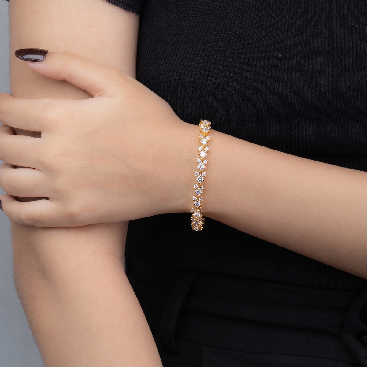 Fizza gold cluster bracelet worn on wrist