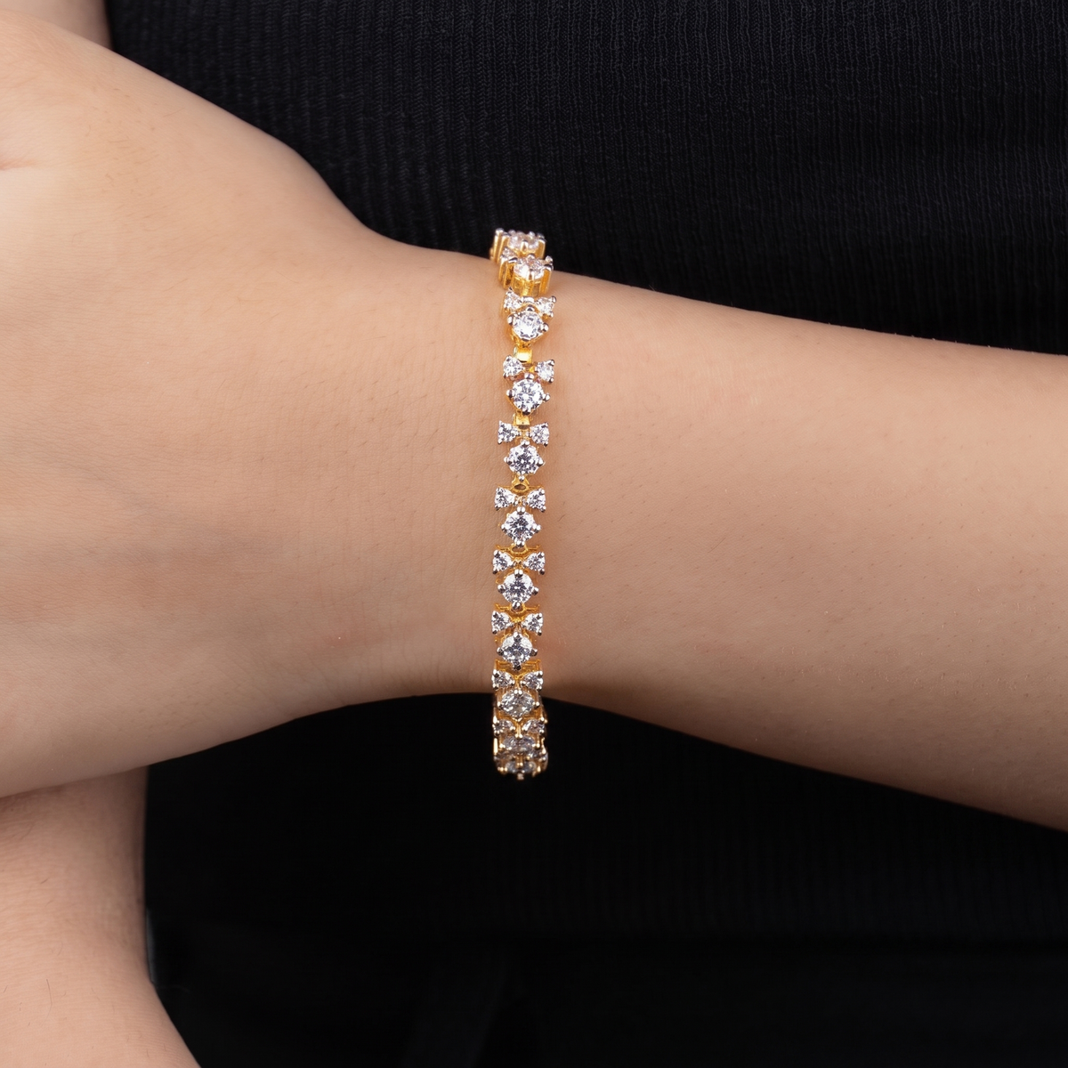 Fizza gold cluster bracelet worn on wrist