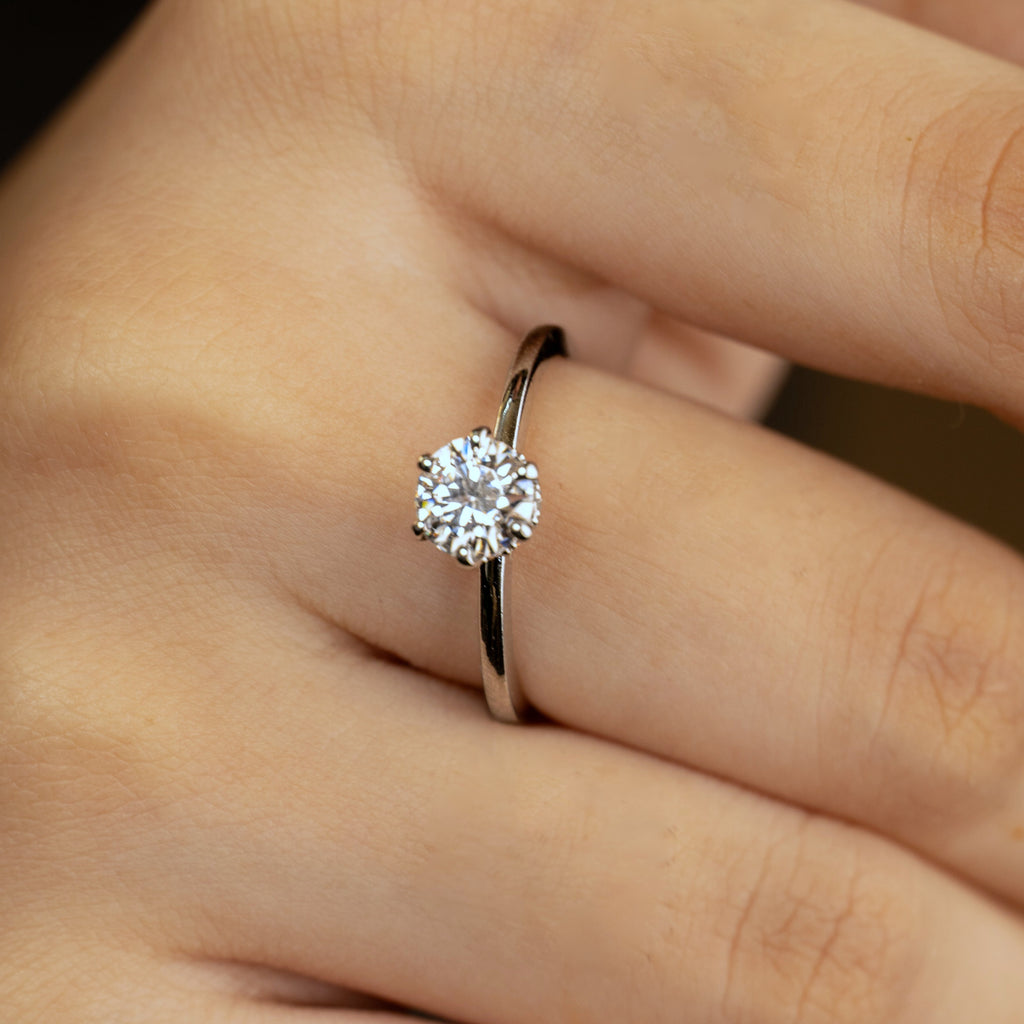 Rhea ring worn on hand — six-prong round solitaire with hidden halo