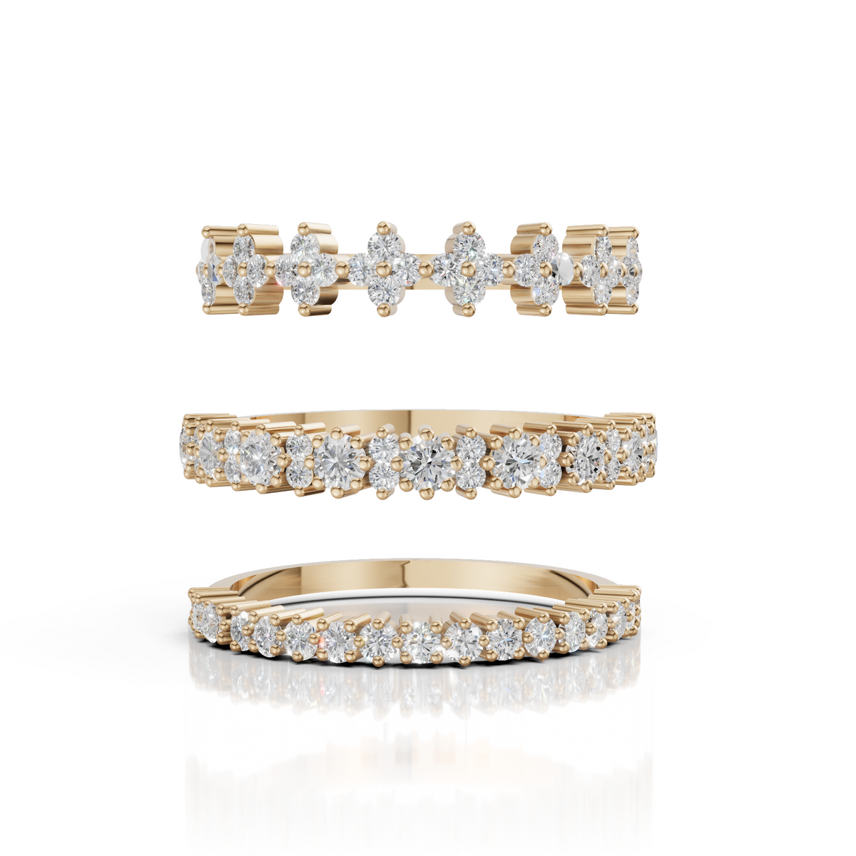 Set of gold rings with diamond accents on a white background